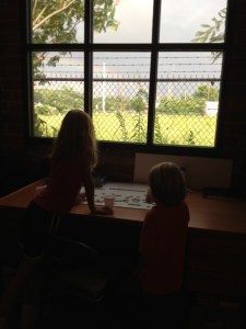 My littles gazing out at the rainbow through the side window at Daybreak