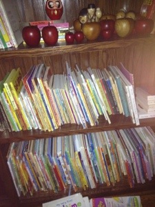My Mama's books tucked away for the night in their own section.  The apples and kokeshi Grandparents use to sit on top of Mama's bookcase.  My children would feed the dolls the apples and then Daddy would move them when they weren't looking.  Too much fun and a sweet memory.  They will move for more books but for today, that is right where they belong.  